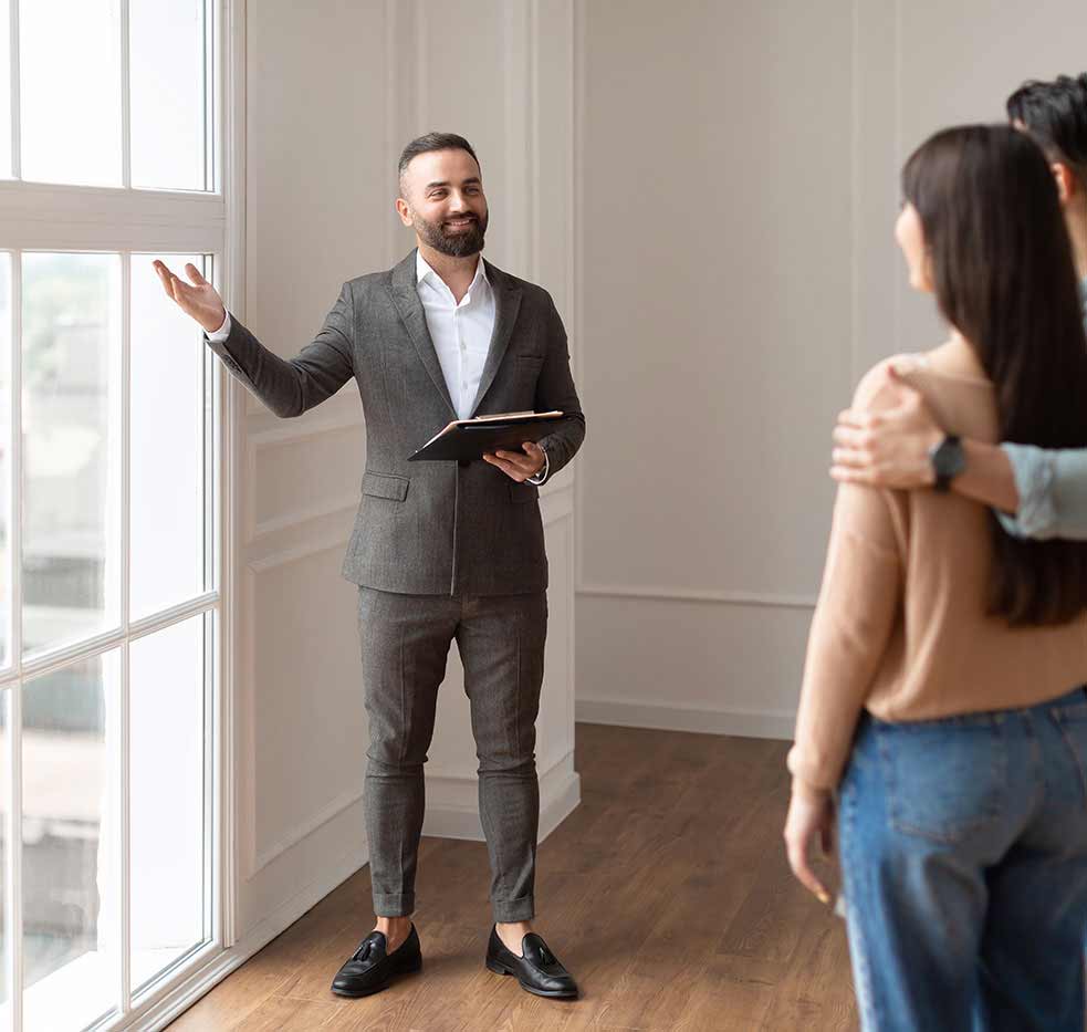 Estate Agent Showing a Couple an Apartment